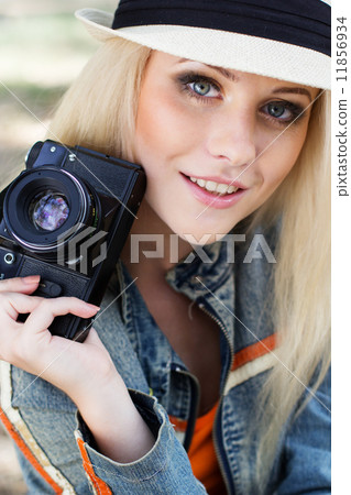 Nice blonde girl photographer with camera 11856934