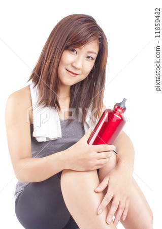 Young and fit pretty girl in exercise outfit holding red water bottle 11859482