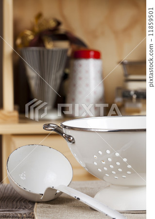 Ladle is next to a colander 11859501