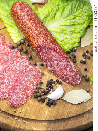 sausages on a wooden plate with vegetables in a restaurant 11860154