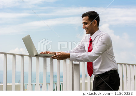 Asian businessman usine laptop outdoor 11860328