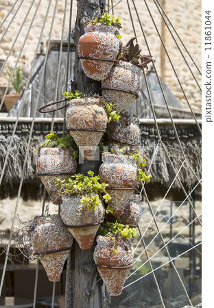 flower pots on a wooden post 11861044
