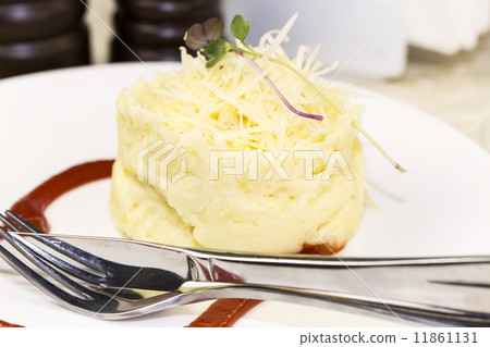 mashed potatoes with herbs and cheese on a white background in the restaurant 11861131