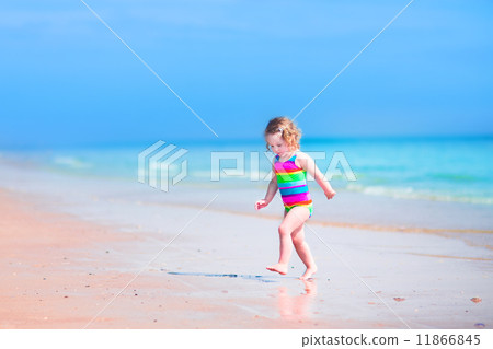Little girl running on a beach 11866845