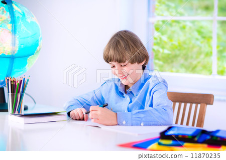Smiling boy doing homework 11870235