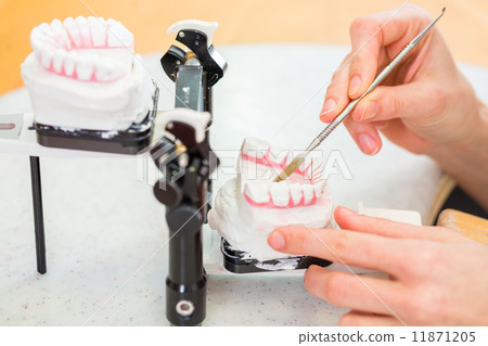 Dental technician producing denture 11871205