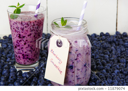 Blueberry smoothie in a glass jar with a straw and sprig of mint 11879074