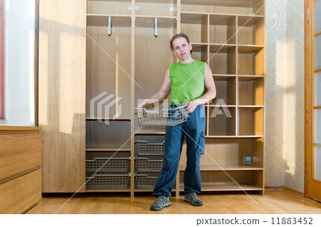 The man is engaged in repair and furniture assemblage.. 11883452