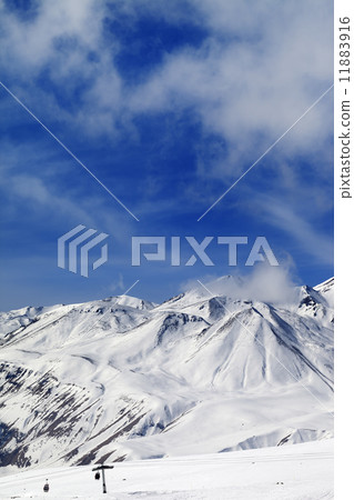 Winter snowy mountains and ski slope 11883916