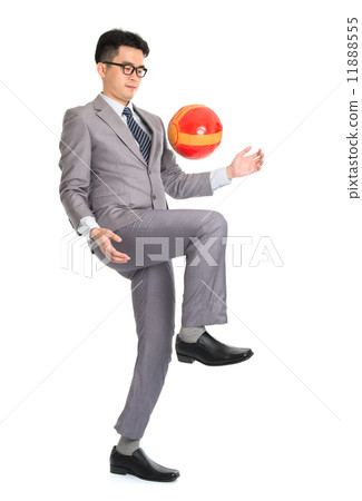Asian businessman playing soccer Asian businessman playing soccer 11888555