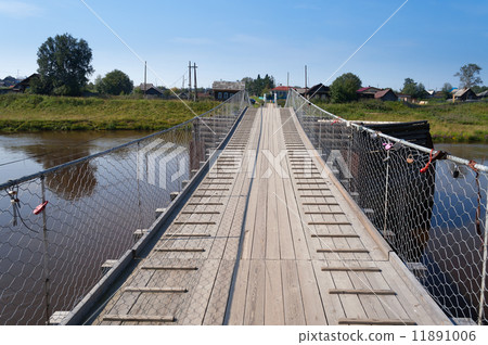 Old suspension bridge over the River Tura 11891006