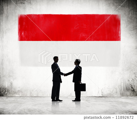 Two Businessmen Shaking Hands With Indonesien Flag As A Backgrou 11892672
