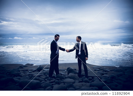 Businessmen Shaking Hands With Stormy Ocean Background 11892904
