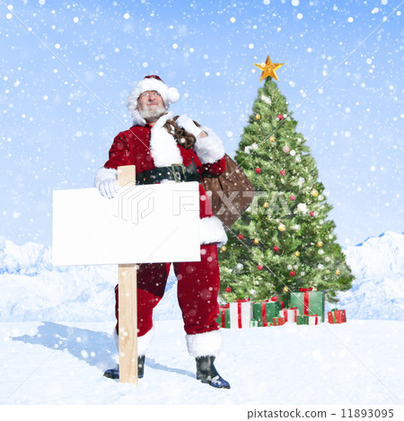 Santa Claus Holding Sack and Blank Placard next to a Christmas T 11893095