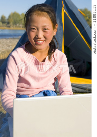 Happy Mongolian Girls with Laptop at Campsite 11893115