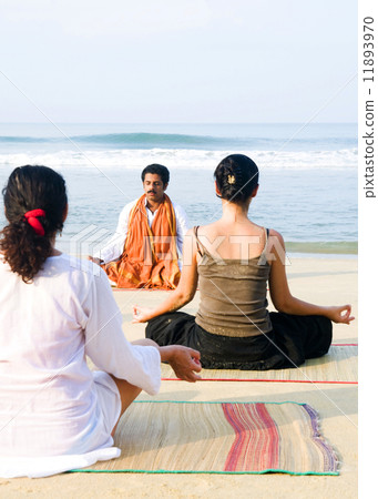 Yoga Instructor And His Students By The Beach Yoga Instructor And His Students By The Beach 11893970