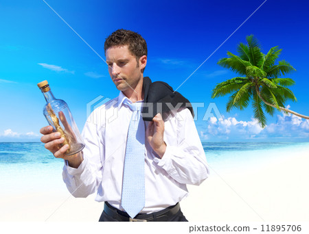 Businessman Looks at Message in a Bottle 11895706