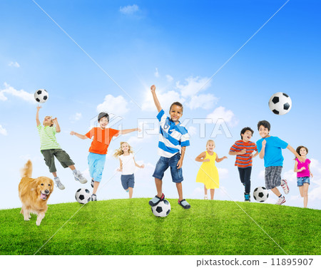 Multi-Ethnic Children Outdoors Playing Soccer Together and a Pet Multi-Ethnic Children Outdoors Playing Soccer Together and a Pet 11895907