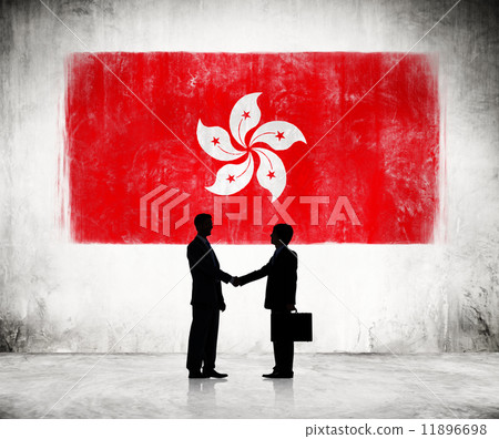 Two Businessmen Shaking Hands With FLag Of Hong Kong As A Backgr 11896698