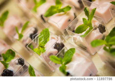 Layered dessert with fruits, nuts and cream cheese in glass jar Layered dessert with fruits, nuts and cream cheese in glass jar 11897786