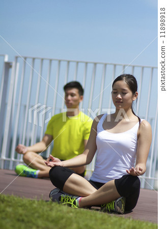 Young Asian Adults practising yoga in the city 11898918