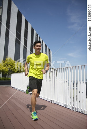 Asian man running Asian man running 11899063