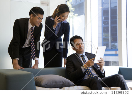 Confident Asian Business Team in discussion 11899592