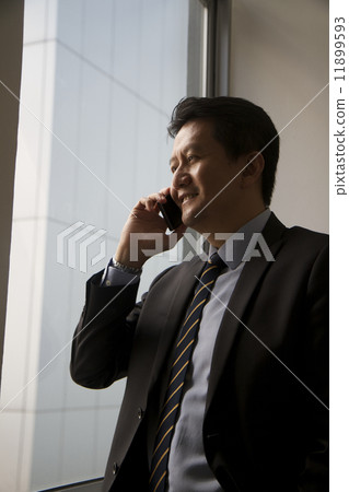 Asian businessman with mobile phone Asian businessman with mobile phone 11899593