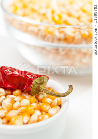 Chili pepper in a bowl of corn grain 11899782