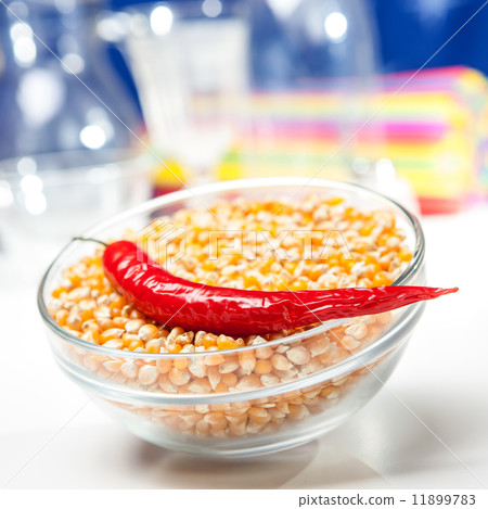 Chili pepper in a bowl of corn grain Chili pepper in a bowl of corn grain 11899783
