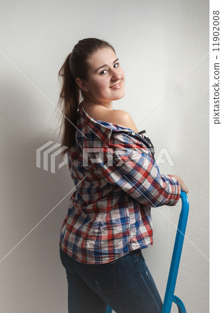 portrait of seductive woman in shirt sitting on metal ladder portrait of seductive woman in shirt sitting on metal ladder 11902008