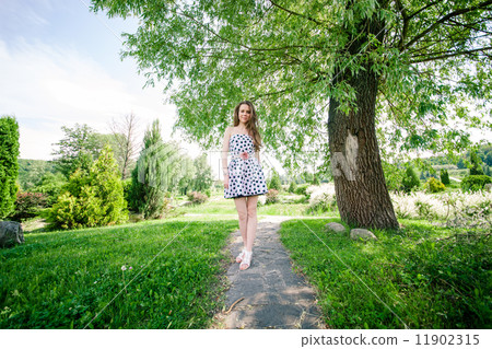 beautiful young woman walking in the park 11902315