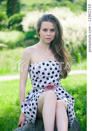 beautiful young woman walking in the park 11902319