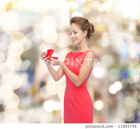 smiling young woman in red dress with gift box smiling young woman in red dress with gift box 11903756
