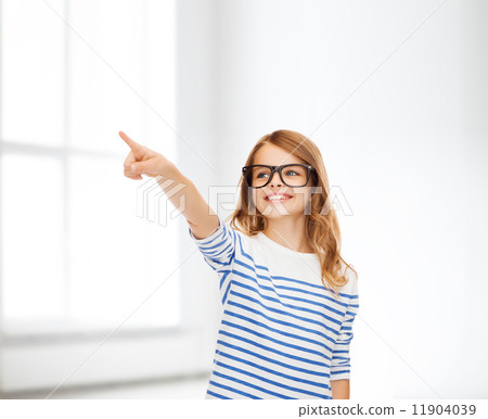 cute little girl in eyeglasses pointing in the air 11904039