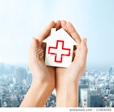 hands holding paper house with red cross hands holding paper house with red cross 11904090