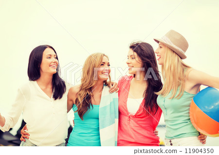 smiling girls with ball and towel on the beach smiling girls with ball and towel on the beach 11904350