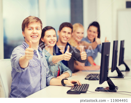 students with computer monitor showing thumbs up students with computer monitor showing thumbs up 11904491