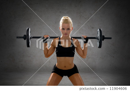 sporty woman exercising with barbell 11904606