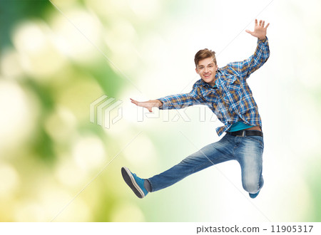 smiling young man jumping in air 11905317
