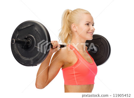 smiling sporty woman exercising with barbell smiling sporty woman exercising with barbell 11905452
