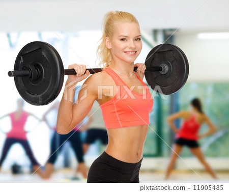 smiling sporty woman exercising with barbell smiling sporty woman exercising with barbell 11905485