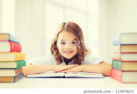 Stock Photo: smiling little student girl with many books