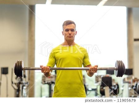 man doing exercise with barbell in gym 11905679