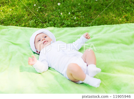 smiling baby lying on floor and looking up 11905946