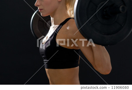 sporty woman exercising with barbell sporty woman exercising with barbell 11906080