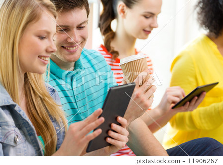 smiling students with tablet pc at school 11906267
