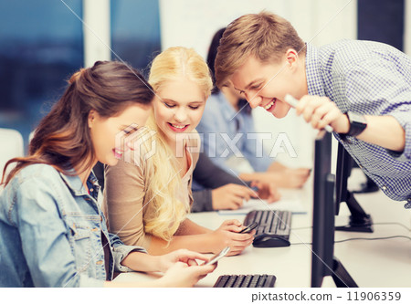 students with computer monitor and smartphones students with computer monitor and smartphones 11906359