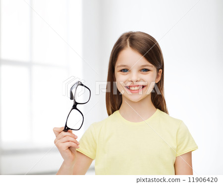 smiling cute little girl holding black eyeglasses 11906420