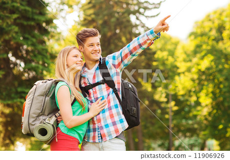 smiling couple with backpacks in nature smiling couple with backpacks in nature 11906926